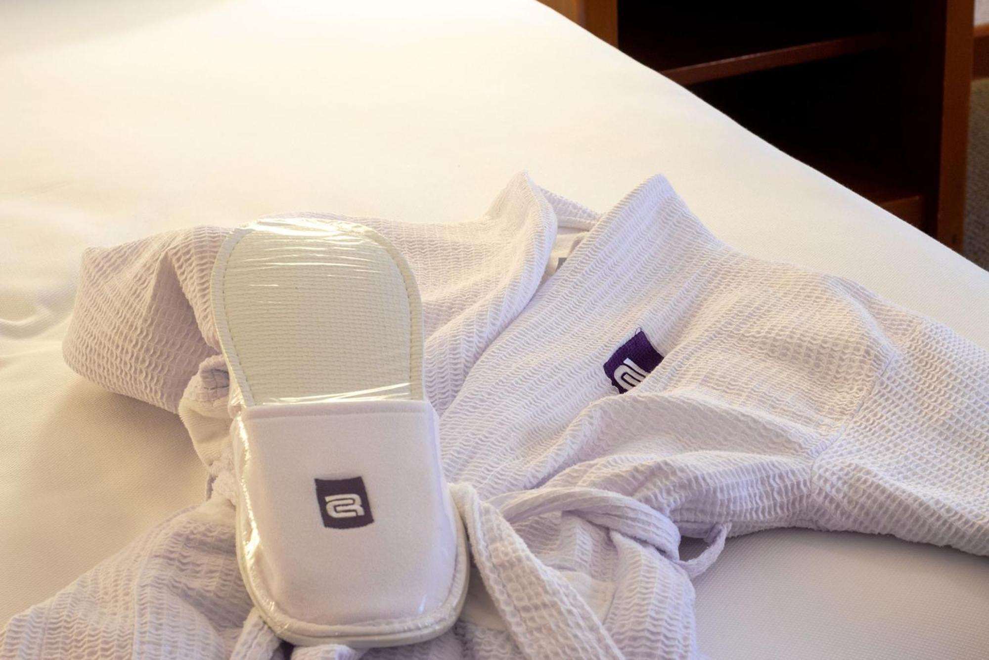 Camino Real Guadalajara Hotel Запопан Екстериор снимка A hotel guest room with a robe and slippers